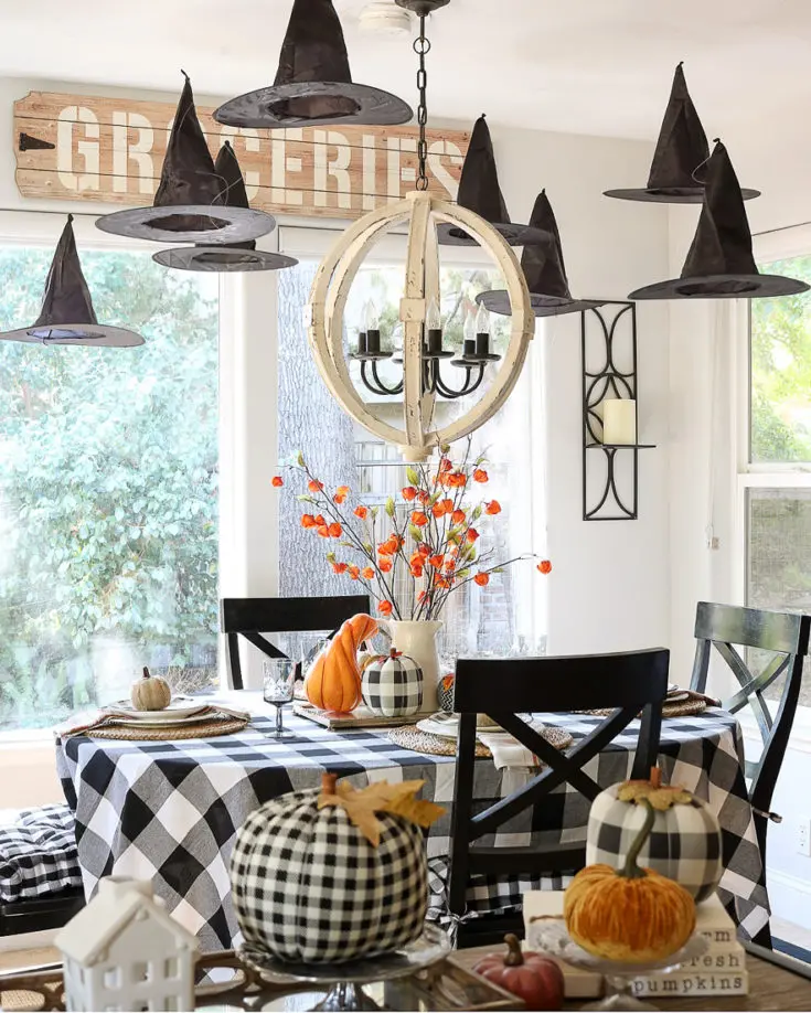 15 Best Farmhouse Halloween Decor 12 halloween table decorated with witches hats e1571089936639.jpg